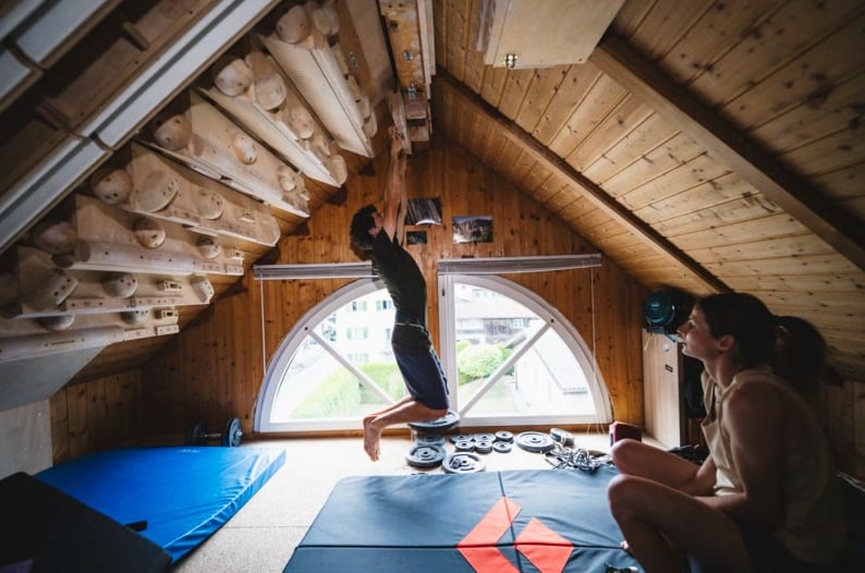 Climbers bouldering in a wooden attic training room